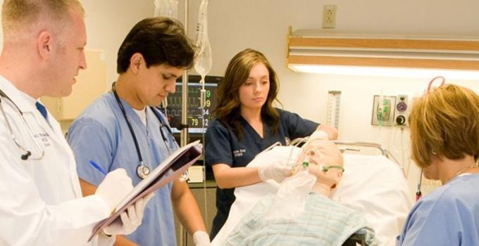 Medical students practice hands-on learning. 