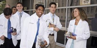 People in white coats smiling
